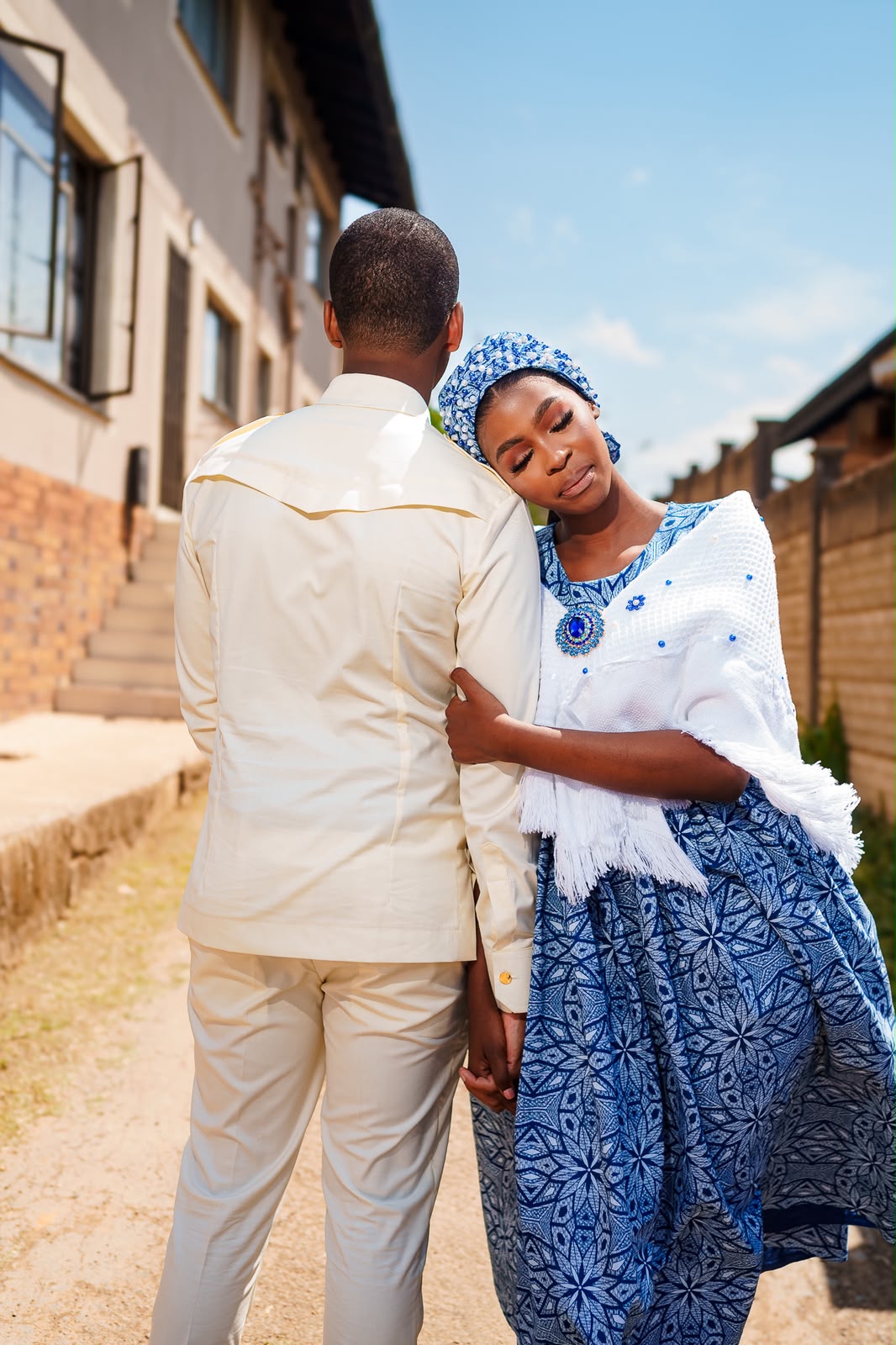 Anele embracing Lindokuhle in their traditional attire